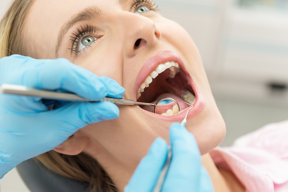 Dentist in Whitby at Downtown Whitby Dentistry performing a routine dental exam and cleaning for a patient